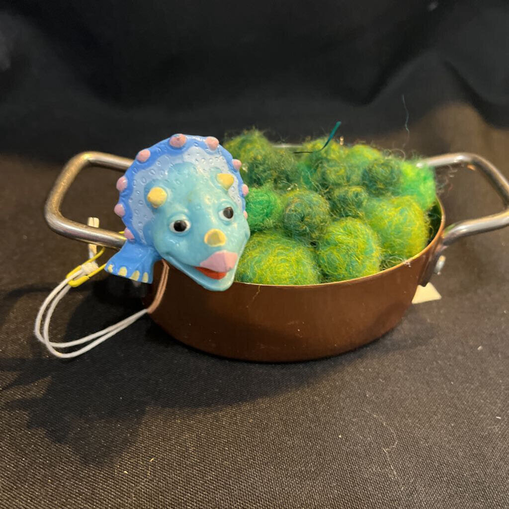 Dinosaur in copper pot w/peas