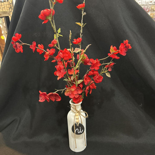 White "HI" vase with red floral flowers
